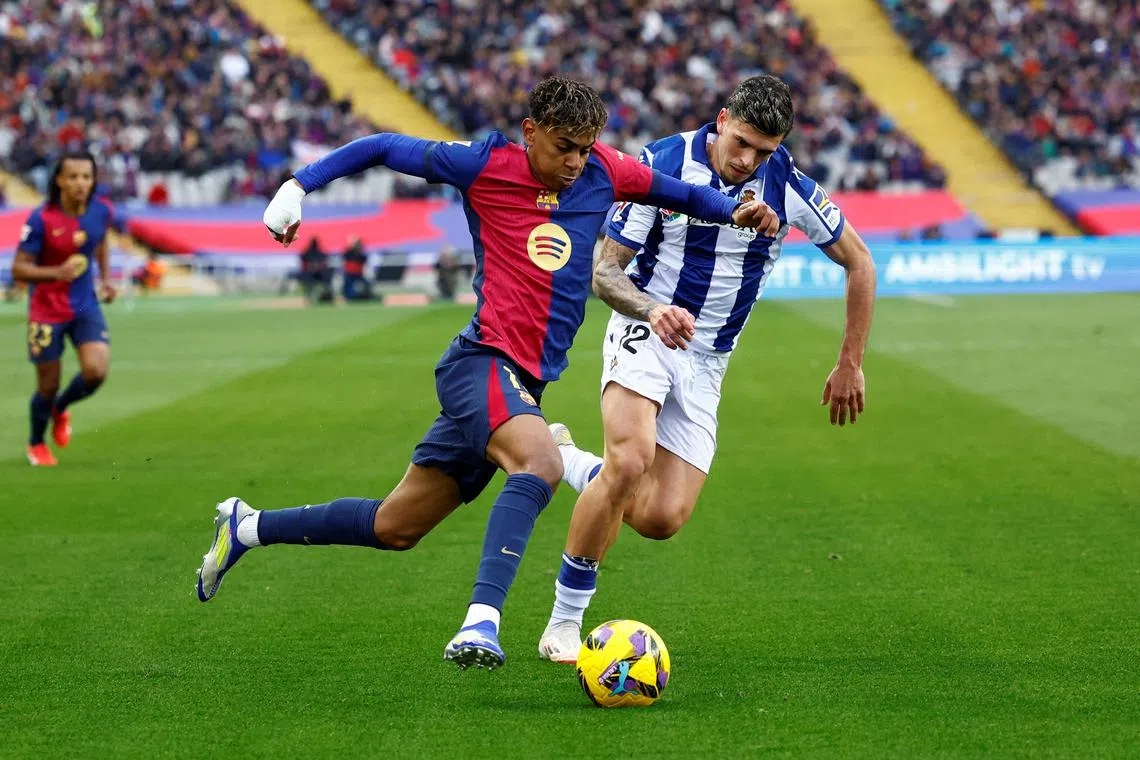 FILE PHOTO: FC Barcelona's Lamine Yamal in action with Real Sociedad's Javi Lopez at Estadi Olimpic Lluis Companys, Barcelona, Spain - March 2, 2025 REUTERS/Albert Gea/File Photo