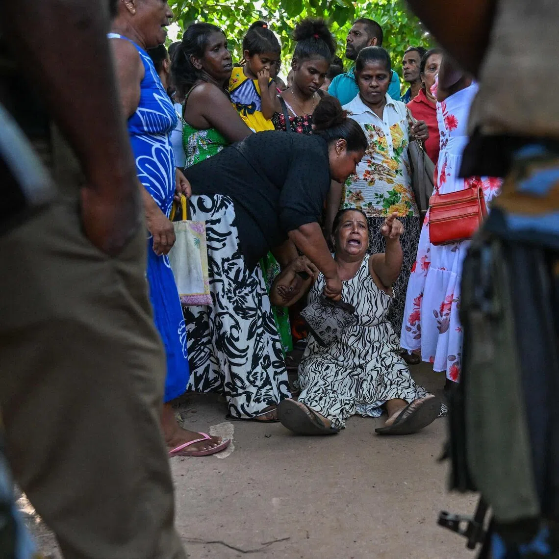 A relative of a victim killed in clashes between inmates of two drug gangs grieves in front of the Negombo prison on the outskirts of Colombo on July 7.