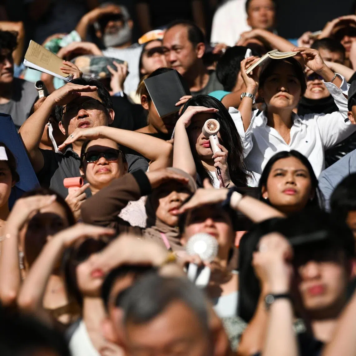 More Singapore travellers are turning to portable cooling devices such as handheld fans, which have grown more popular.