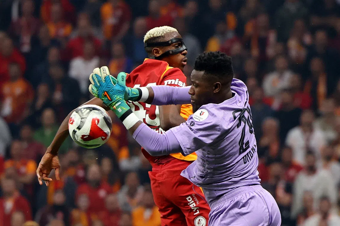 FILE PHOTO: Soccer Football - Super Lig - Galatasaray v Trabzonspor - Rams Park, Istanbul, Turkey - November 1, 2025  Trabzonspor's Andre Onana in action with Galatasaray's Victor Osimhen REUTERS/Murad Sezer/File Photo