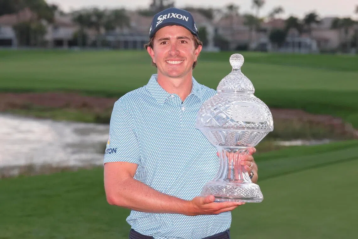 Nico Echavarria holds the champions trophy after winning the Cognizant Classic golf tournament.