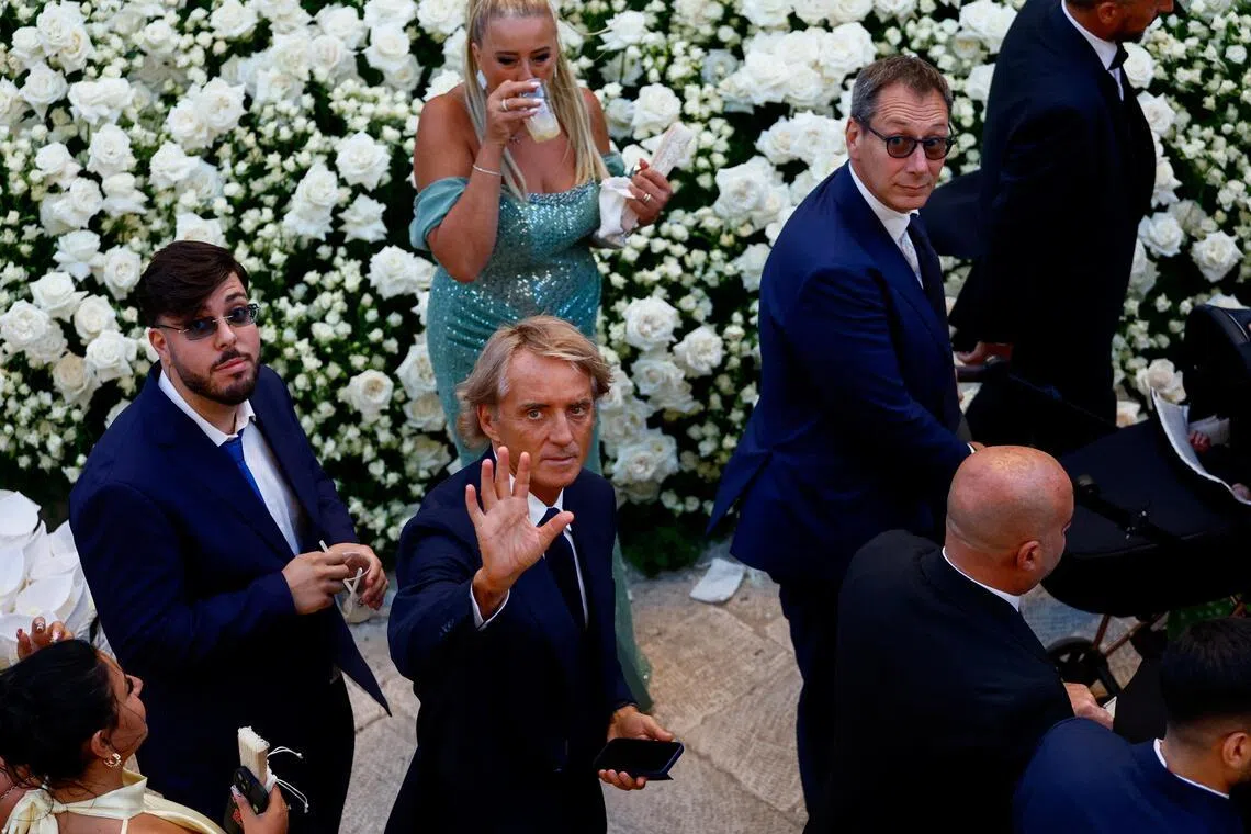 Former Italy coach Roberto Mancini waves toward photographers following the wedding ceremony of Manchester City and Italy goalkeeper Gianluigi Donnarumma and Alessia Elefante at the Chiesa Madre di San Giorgio Martire in Locorotondo, southern Italy, on July 24, 2026.