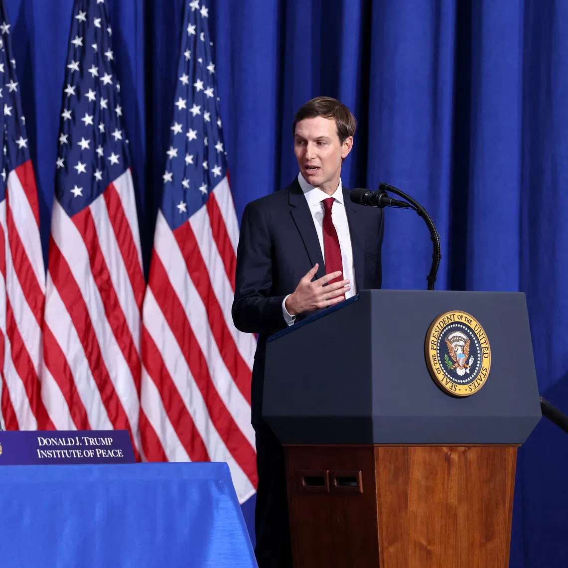 US President Donald Trump listens, as his son-in-law Jared Kushner (right) speaks, during the inaugural Board of Peace meeting at the US Institute of Peace in Washington DC, on Feb 19.