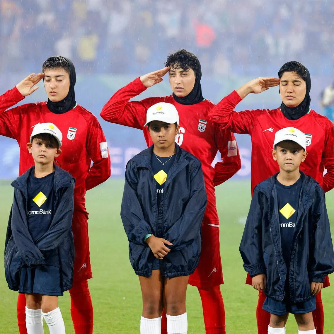 Iran's players salute during the national anthem before the AFC Women's Asian Cup Australia 2026 football match between Iran and Philippines in Gold Coast on March 8, 2026. 