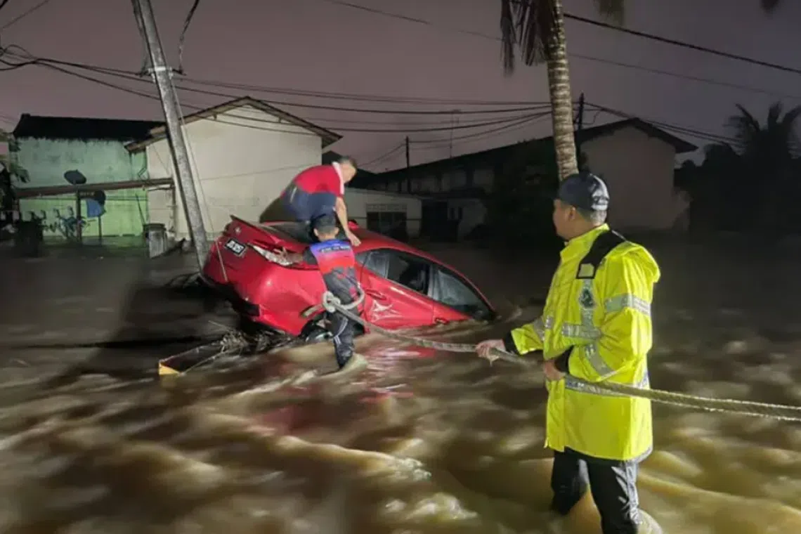 A man was rescued after his car was swept away by water currents near Taman Aman.