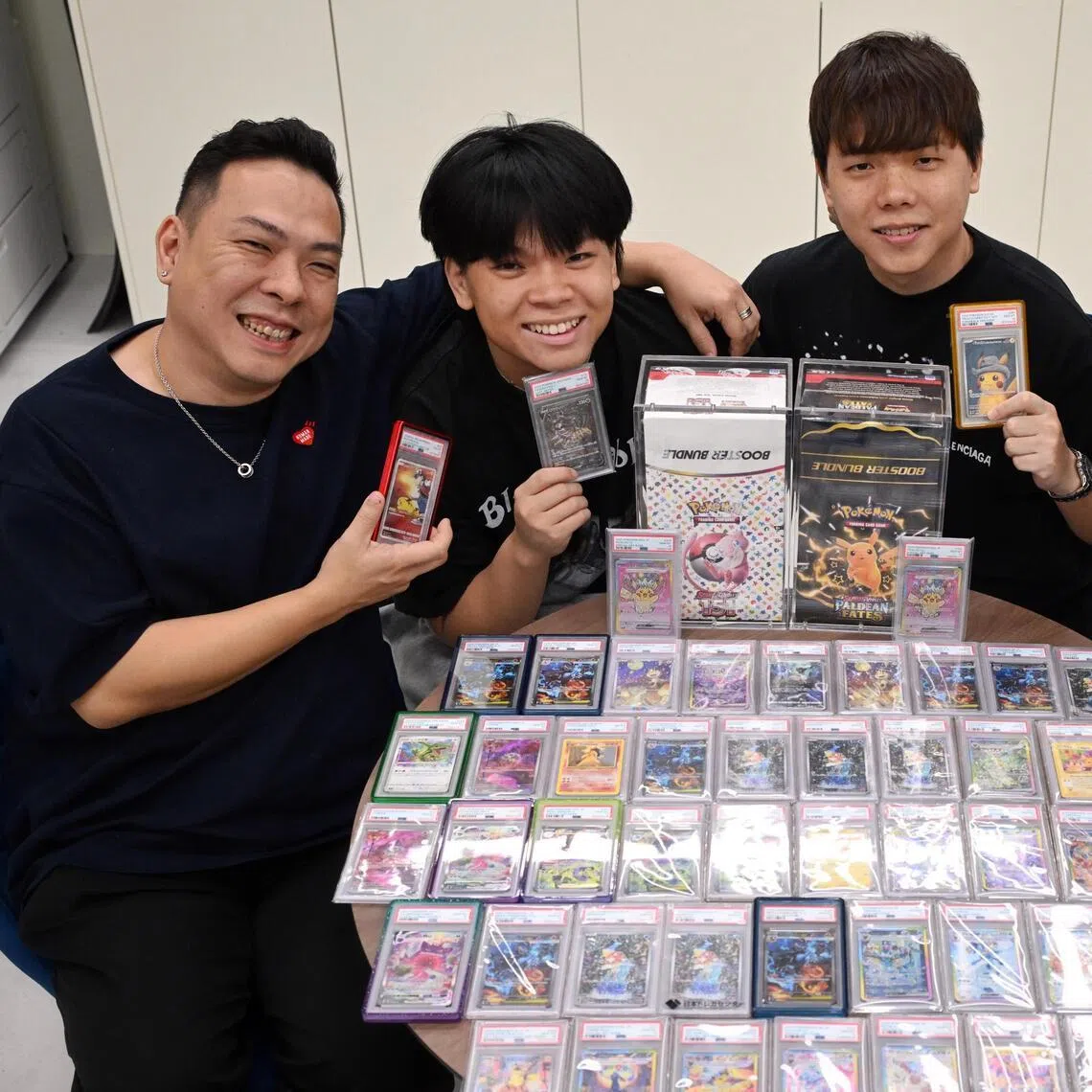 Mr Andy Chua (second from right) roped in (from left) Mr Gab Chua, Mr Glenn Chua, and Mr Bryan Leong to start Pokemakase, a family-run venture that buys, sells and trade Pokemon cards.