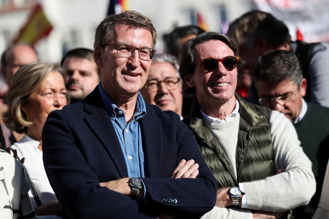 FILE PHOTO: People's Party leader Alberto Nunez Feijoo and former Spanish Prime Minister Jose Maria Aznar attend a protest against the Socialist government of Pedro Sanchez and its agreements with Catalan separatist parties over an amnesty law, in Plaza Espana, Madrid, Spain, January 28, 2024. REUTERS/Isabel Infantes/File Photo