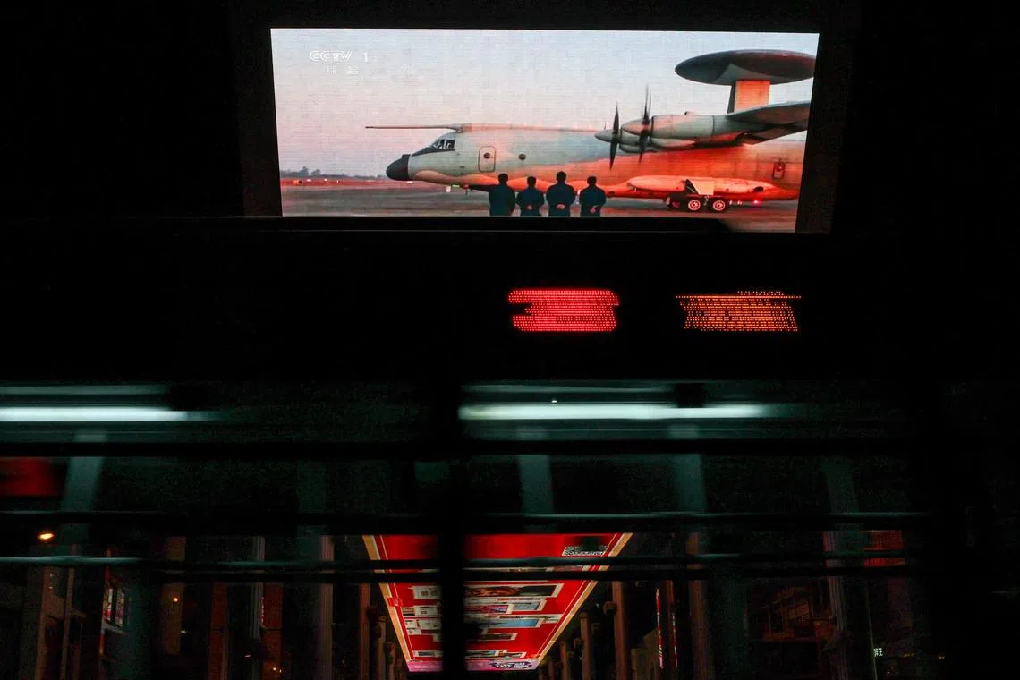 A giant screen showing a news report on China's "Justice Mission 2025" military drills around Taiwan, in Beijing, China, on December 30, 2025.