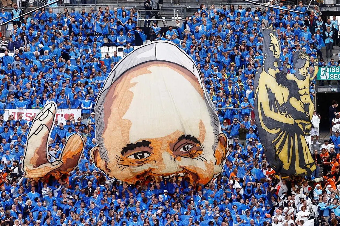 A general view of an image representing Pope Francis, as people gather on the day Pope Francis holds a mass at the Velodrome Stadium as a part of his journey on the occasion of the Mediterranean Meetings (MED 2023) in Marseille, France, Sept 23.