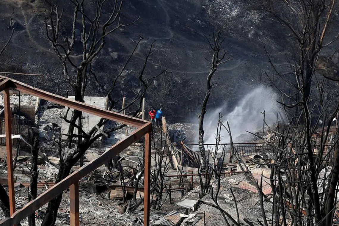 Remains of burned houses are seen following the spread of wildfires in Vina del Mar, Chile, February 5, 2024. REUTERS/Rodrigo Garrido