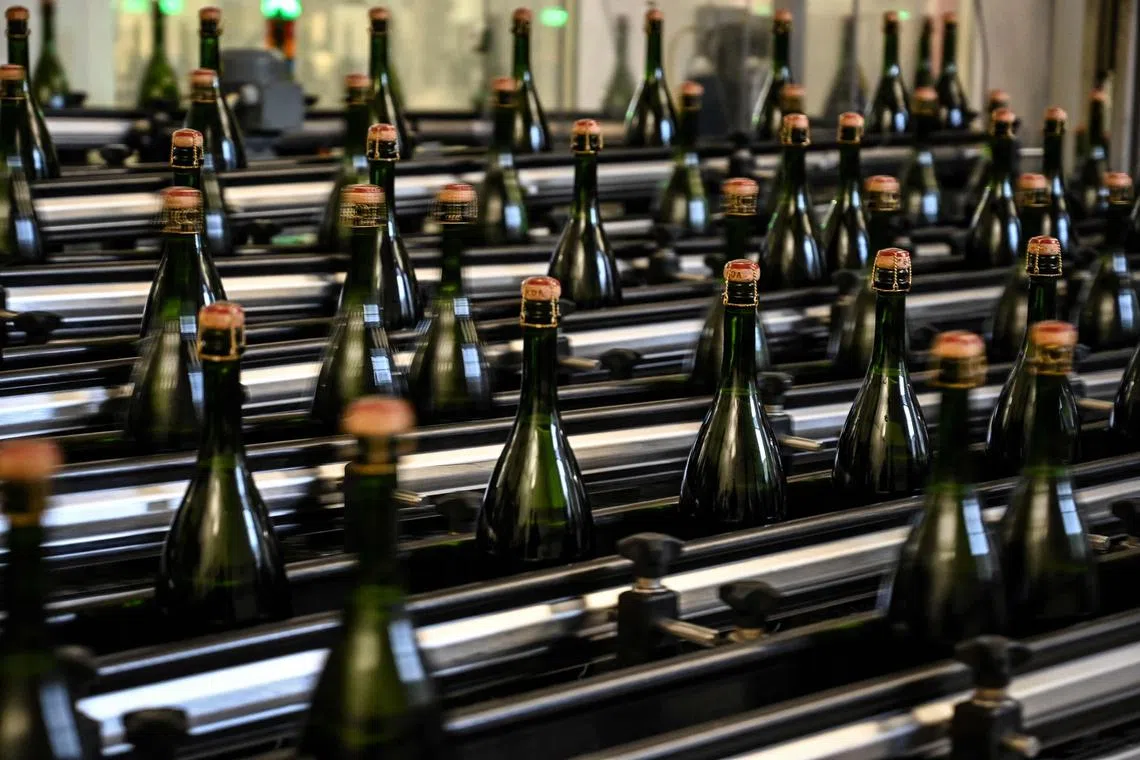 Bottles of the French champagne house Bollinger on a control and quality chain in Ay, near Epernay, Northern France. 