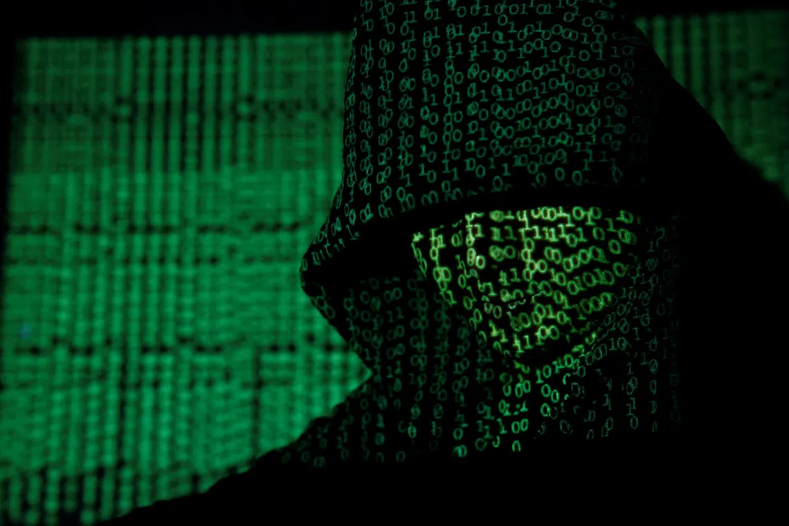 A projection of cyber code on a hooded man is pictured in this illustration picture taken on May 13,  2017. REUTERS/Kacper Pempel/Illustration