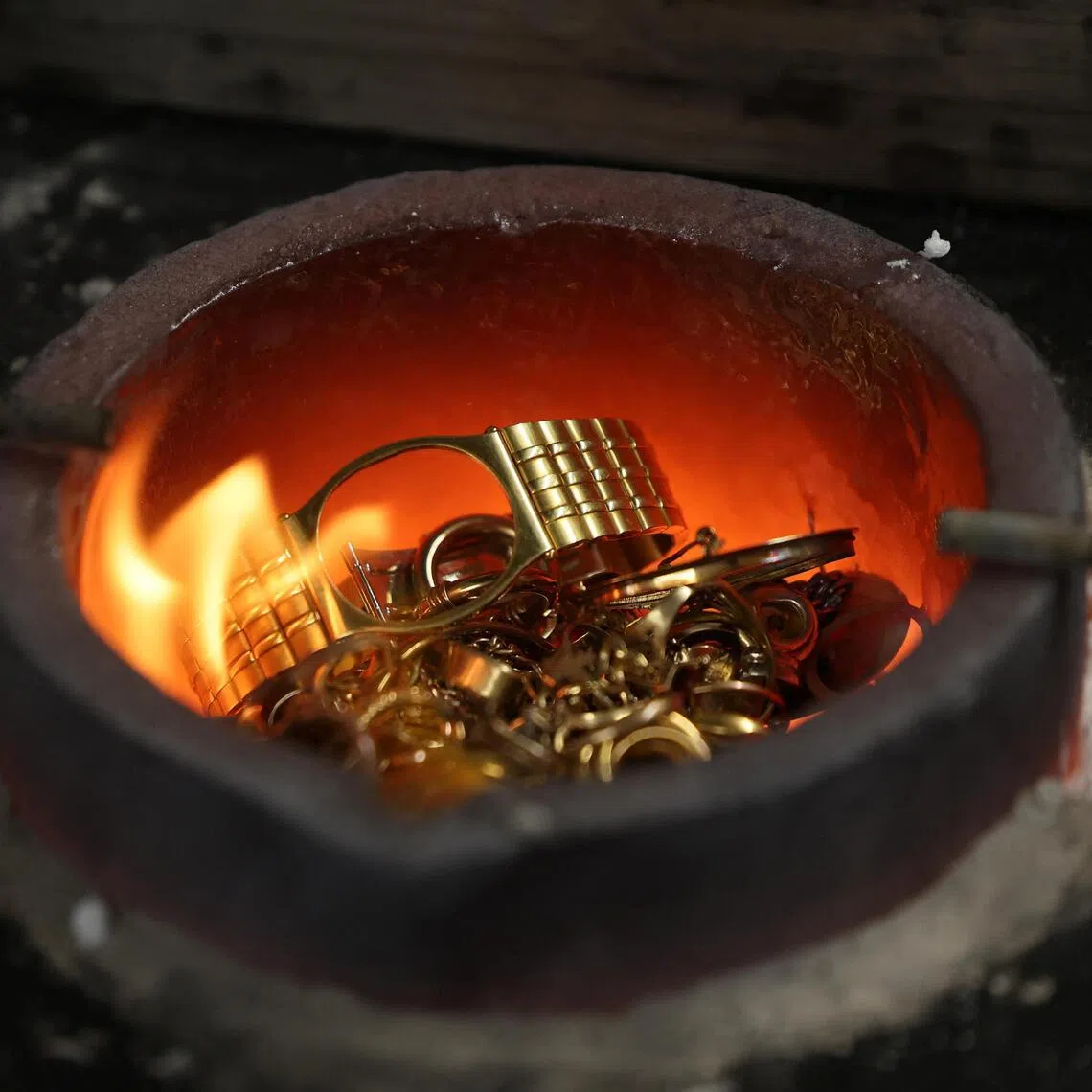 An old luxury watch is placed into a furnace to be melted down for gold at Hatton Garden Metals in London, Britain, June 10, 2026. REUTERS/Toby Shepheard