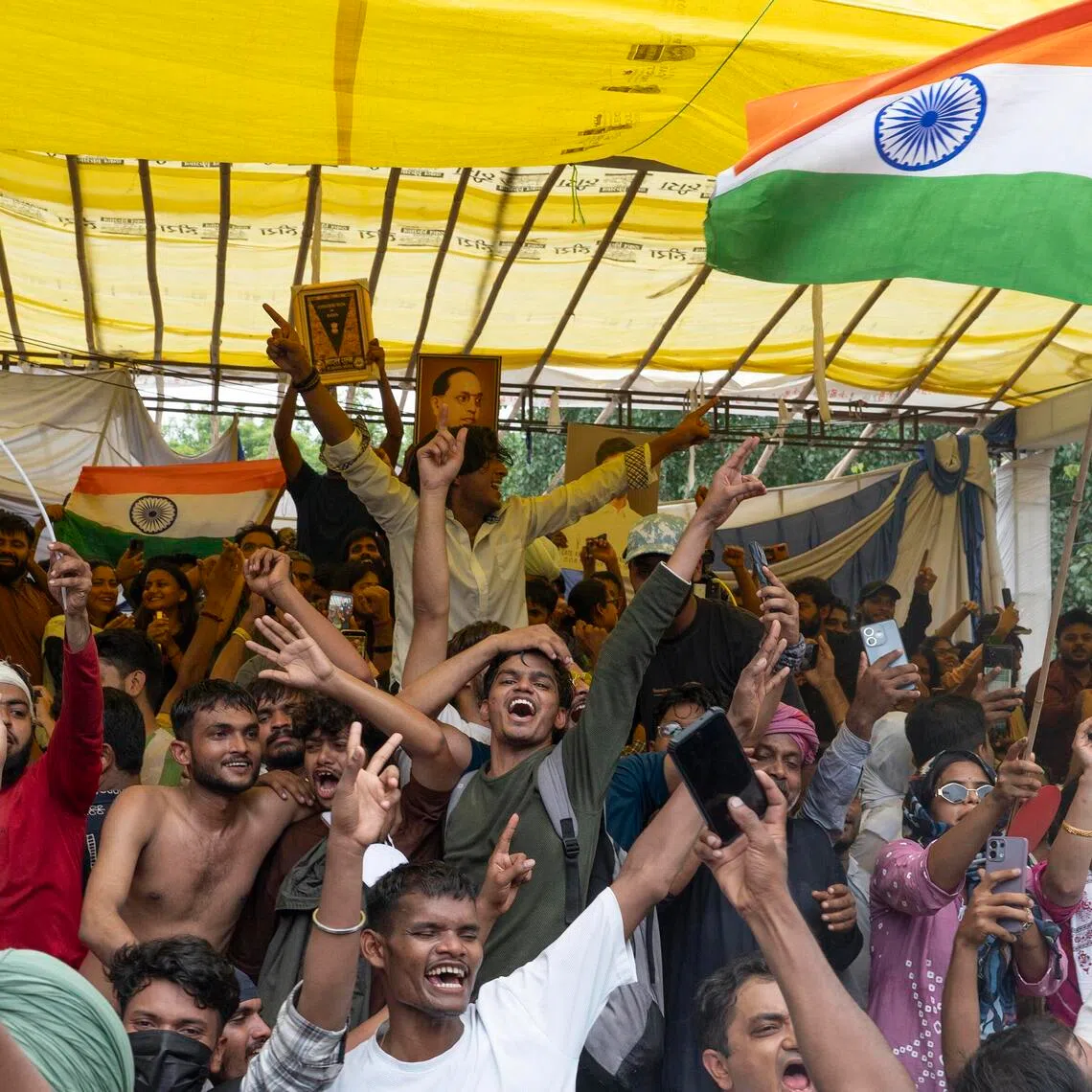 Supporters of the Cockroach Janta Party celebrate the resignation of Education Minister Dharmendra Pradhan on July 25.