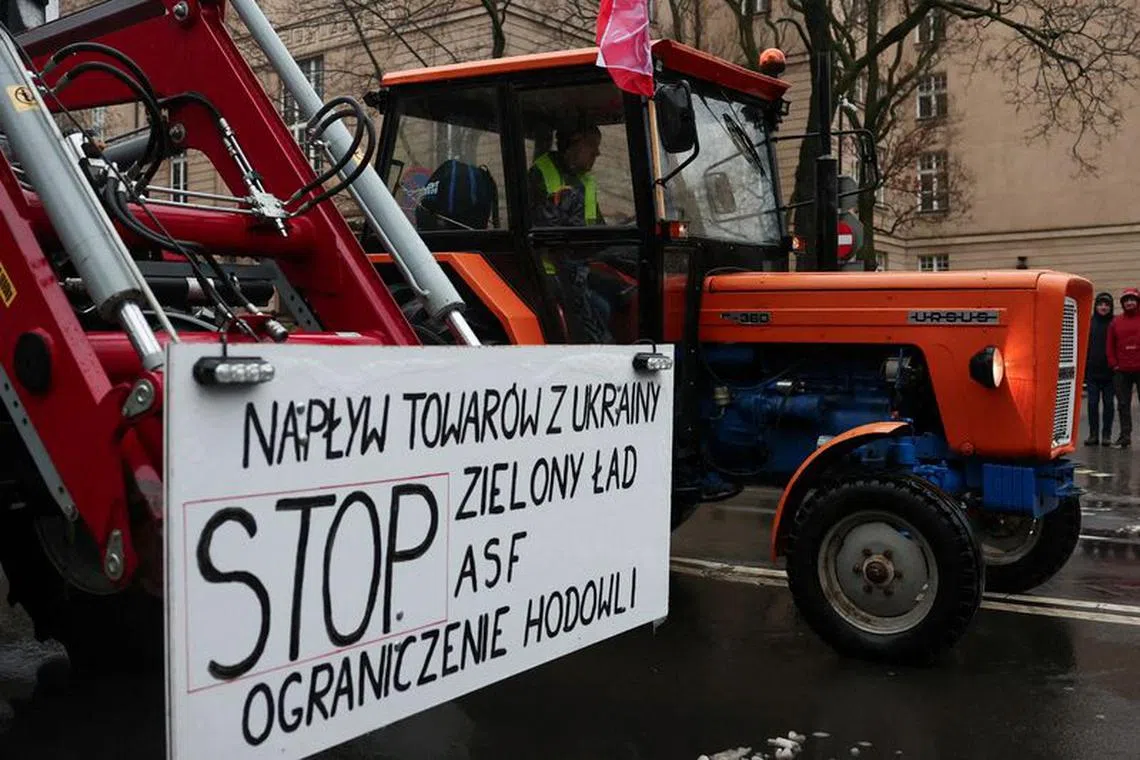 FILE PHOTO: A Polish farmer uses a tractor on a road during a protest over price pressures, taxes and green regulation, grievances shared by farmers across Europe, in Poznan, Poland, February 9, 2024. REUTERS/Kacper Pempel