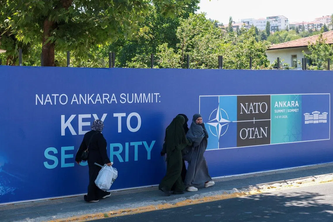 People walk past billboards built for upcoming NATO summit in Ankara, Turkey, July 1, 2026. REUTERS/Efekan Akyuz