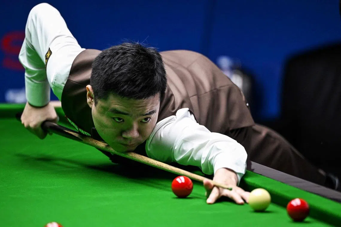 China's Ding Junhui, seen here at the Shanghai Masters on Sept 13, had donned his usual brown snooker suit with bow tie and waistcoat, having forgotten about the all-black dress code for the event held in Brentwood near London. 