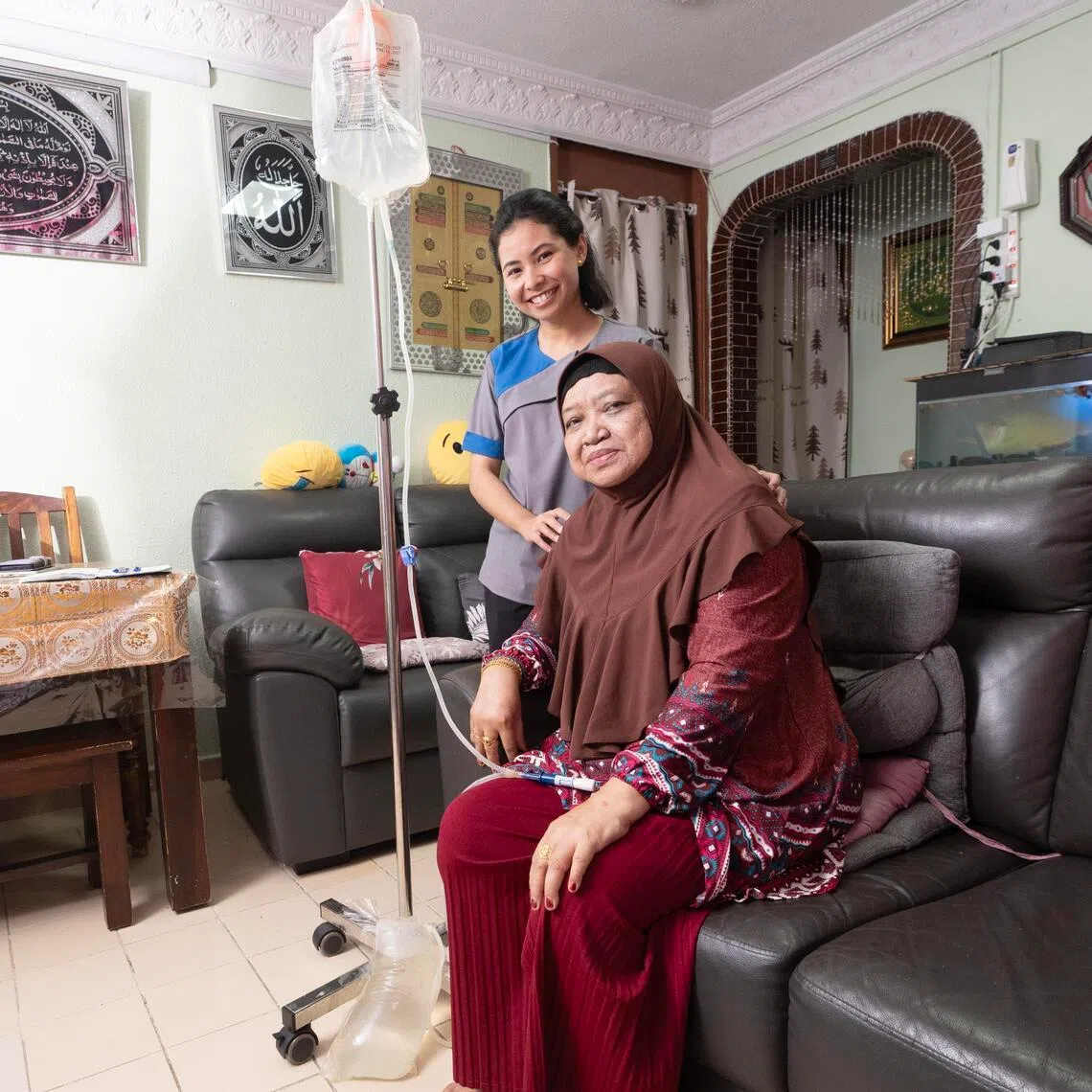 Experienced peritoneal dialysis nurses like Ms Shadirah Zaharum (left) help patients like Madam Norhyati Buang manage their condition, offer advice on living conditions and provide emotional support. 