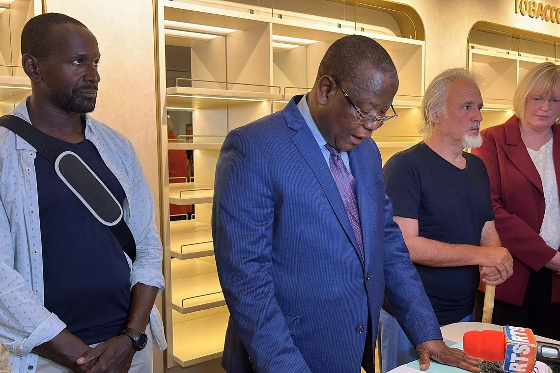 French journalist Olivier Dubois and US aid worker Jeffery Woodke listen to Niger's Interior Minister Hamadou Adamou Souley on March 20, 2023.