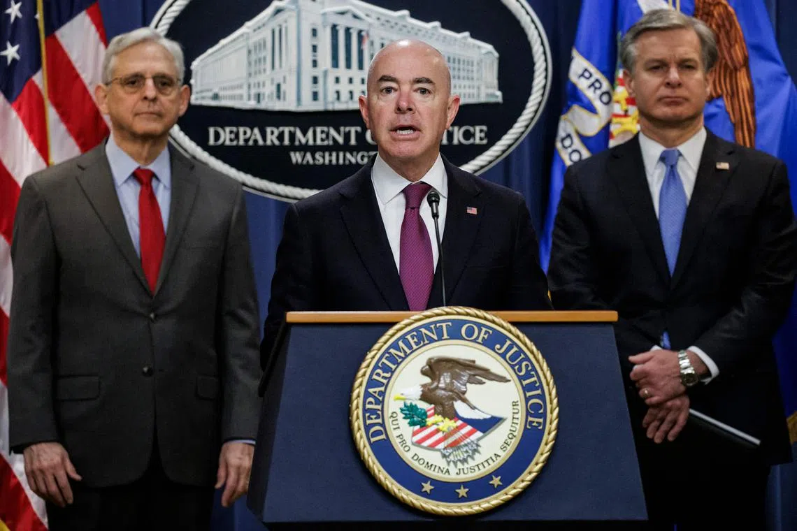 US Homeland Security Secretary Alejandro Mayorkas, flanked by Attorney General Merrick Garland (left) and FBI Director Christopher Wray, at a press conference in Washington on Dec 6.