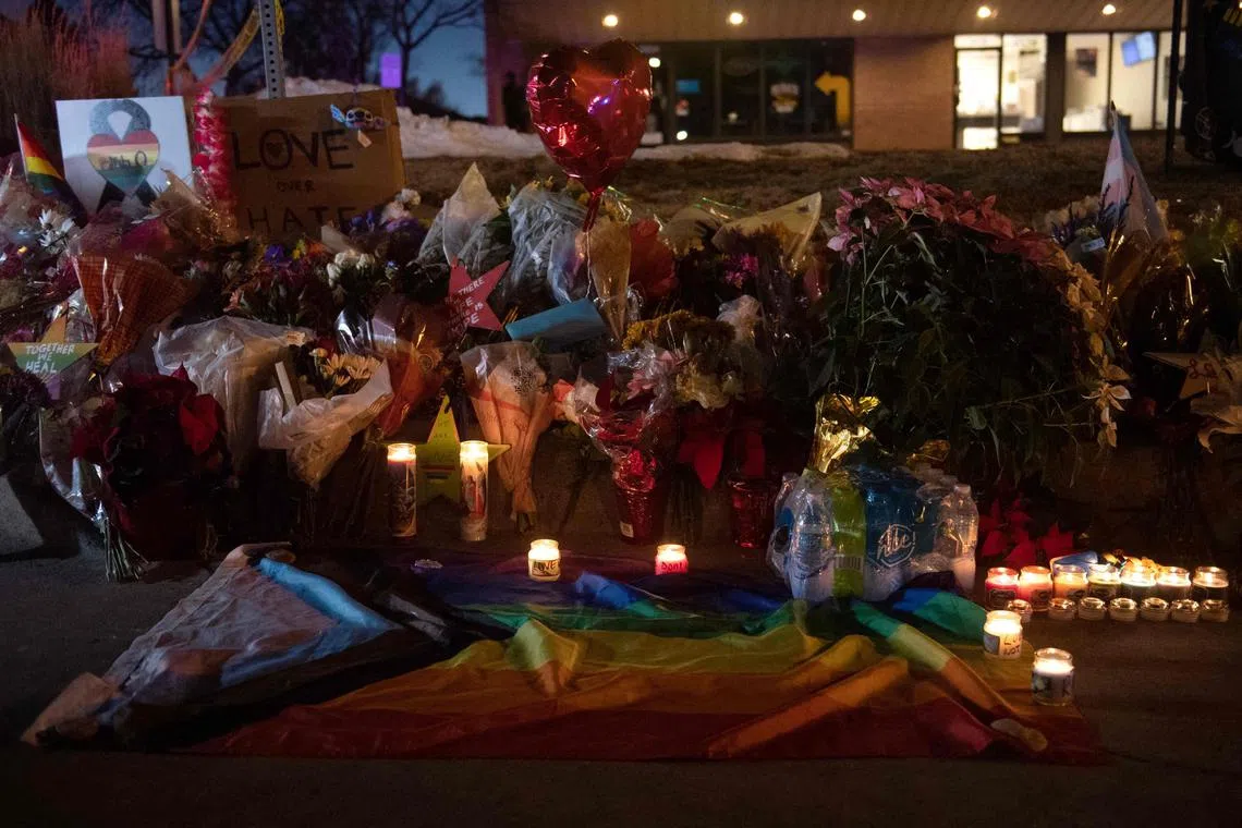 (FILES) Flower bouquets, candles, and other items form a memorial near the LGBTQ nightclub, Club Q, in Colorado Springs, Colorado on November 20, 2022. A mass shooter who killed five people at an LGBTQ club in the US state of Colorado pleaded guilty to hate crimes on June 18, 2024 over the horrifying 2022 massacre, and was given another hefty sentence. (Photo by Jason Connolly / AFP)