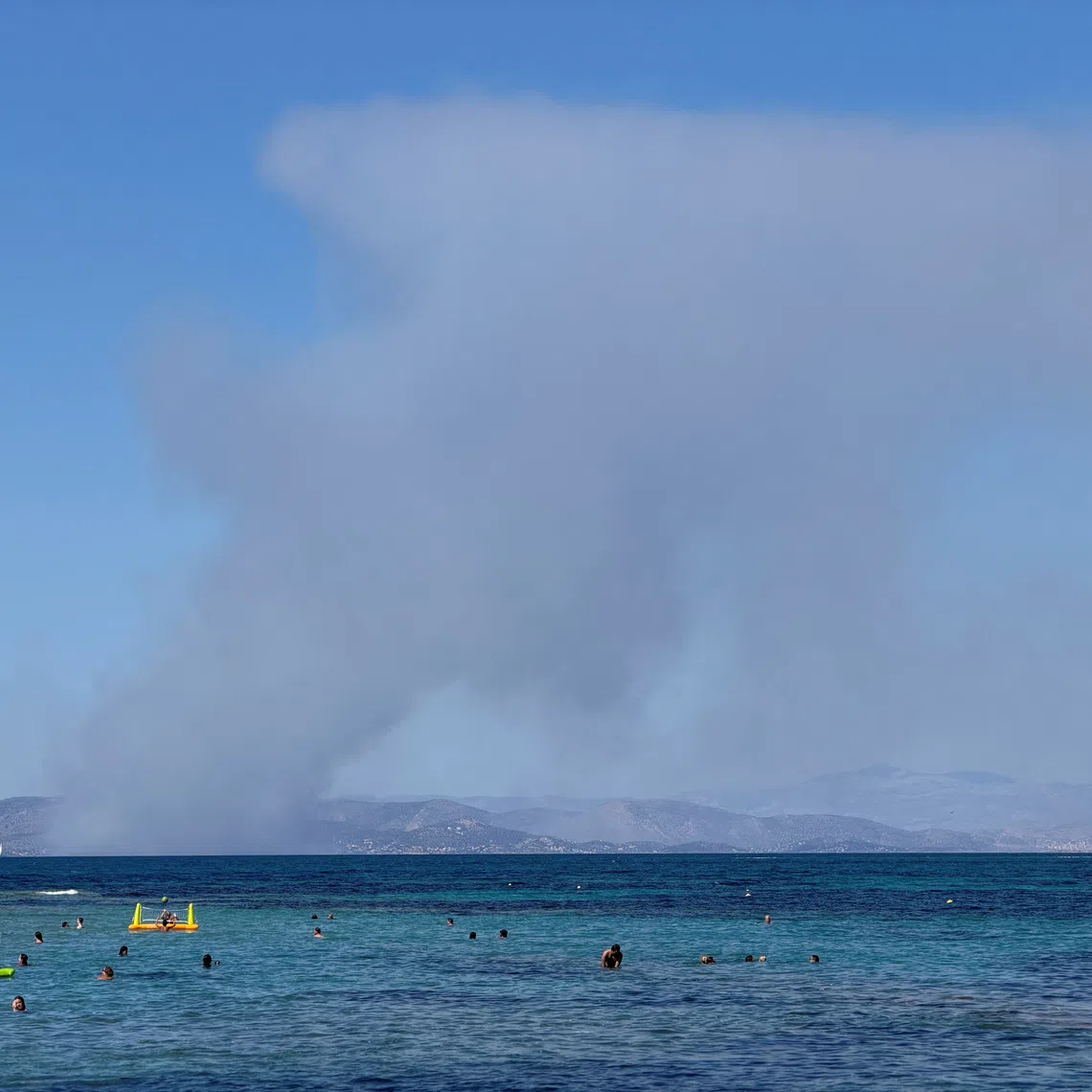 Smoke rises in Salamina during wildfire as seen from Agistri island, Greece, August 16, 2026 in this screengrab taken from a social media video. Symeon (Simon) Kranz/via REUTERS