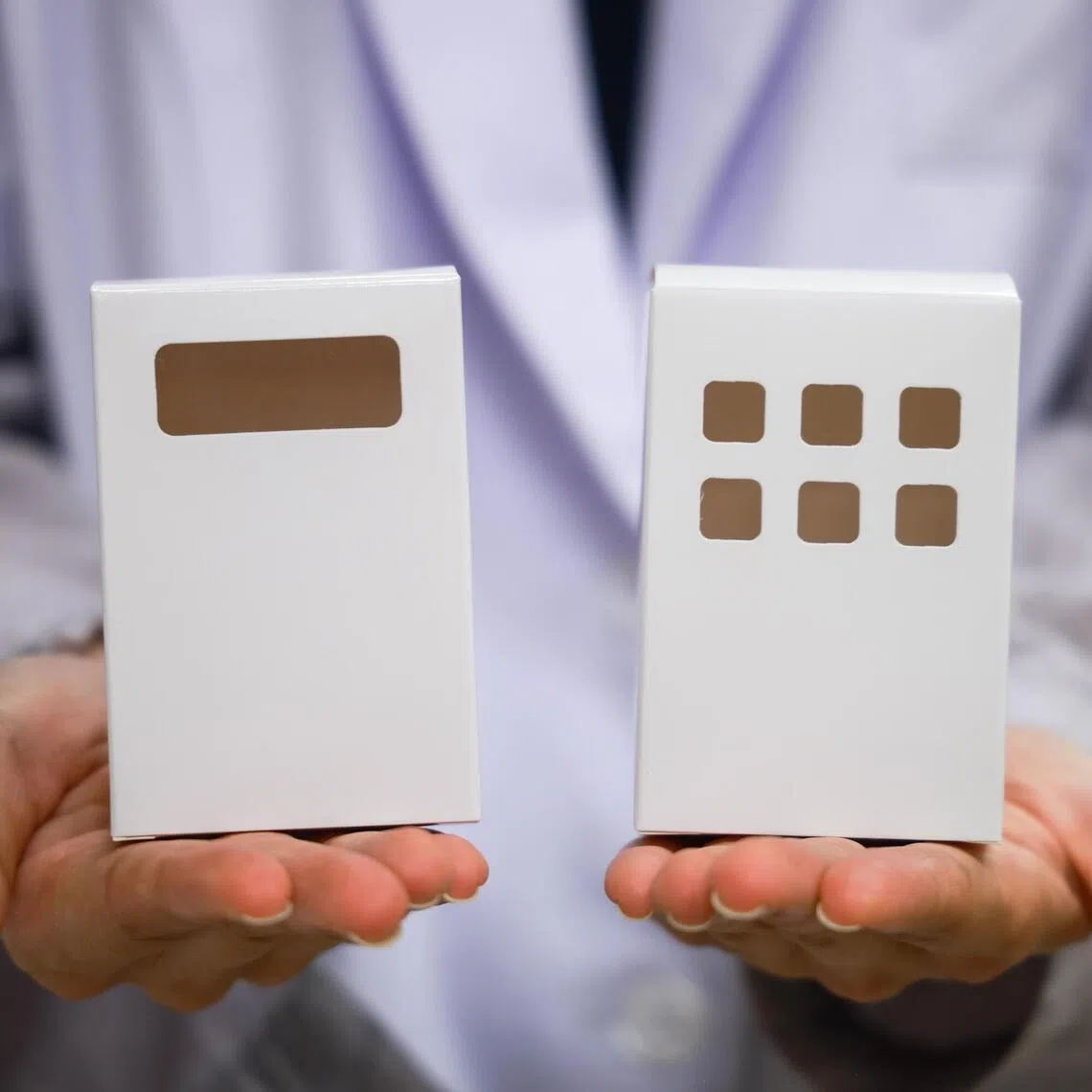 Tan Tock Seng Hospital’s pharmacists designed a single-material paper medication box (right) by removing the plastic component, making it suitable for recycling. On the left is the previous box, with a small plastic window.