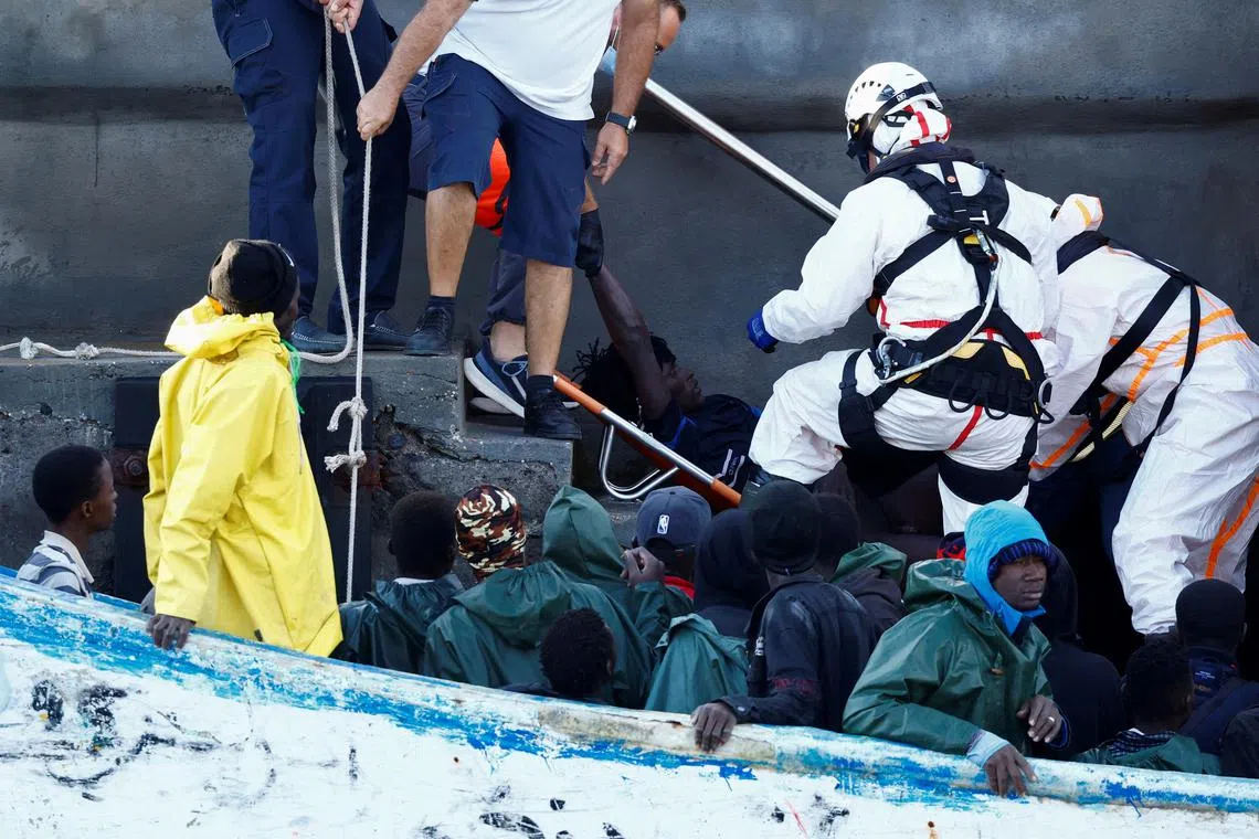 FILE PHOTO: Rescuers disembark a migrant in serious health condition at the port of La Restinga on the island of El Hierro, Spain, September 30, 2024. REUTERS/Borja Suarez/File Photo