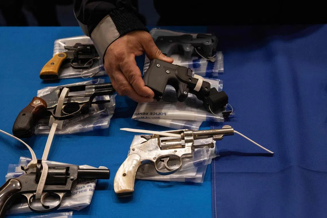 Kings County District Attorney Eric Gonzalez holds a 3D printed ghost gun during a statewide gun buyback event held by the office of the New York State Attorney General, in the Brooklyn borough of New York on April 29, 2023. - Some 90 firearms and parts were turned in during a 3-hour event. (Photo by Yuki IWAMURA / AFP)