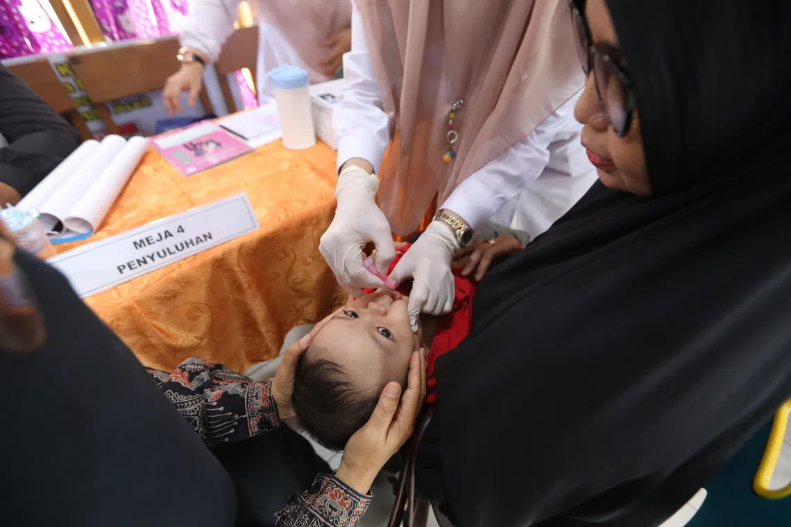 A healthcare worker examining a child during a health check campaign for the elderly and children in Banda Aceh, Indonesia, Oct 14, 2025. 