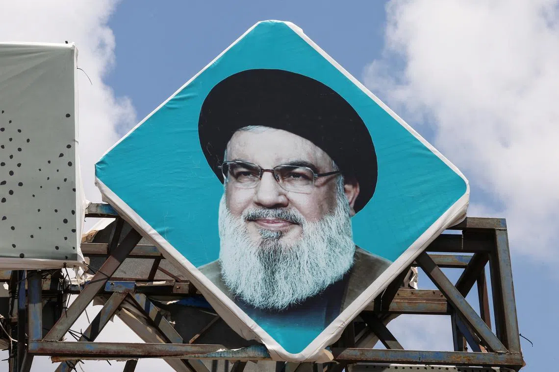 FILE PHOTO: A sign depicting Lebanon's Hezbollah leader Sayyed Hassan Nasrallah is placed in the southern port city of Tyre, Lebanon July 30, 2024. REUTERS/Aziz Taher/File Photo