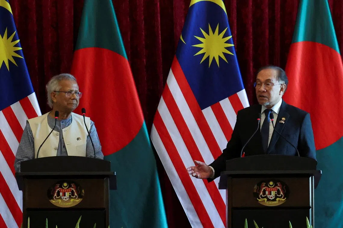 Malaysian Prime Minister Anwar Ibrahim speaks as Chief Adviser of Bangladesh Interim Government Muhammad Yunus looks on during a press conference at Putrajaya, Malaysia, August 12, 2025. REUTERS/Hasnoor Hussain/Pool