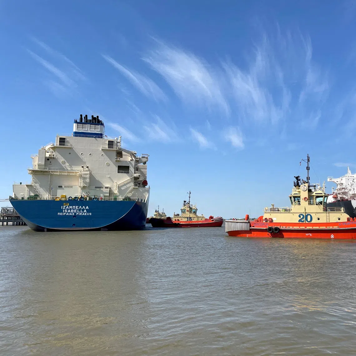 An LNG tanker is guided by tugboats at the Cheniere Sabine Pass LNG export unit in Cameron Parish, Louisiana, the US.