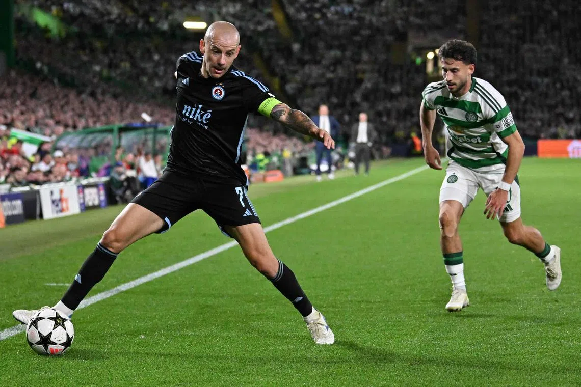 Slovan Bratislava's Slovakian midfielder Vladimir Weiss (left) fending off Celtic's German midfielder Nicolas Kuhn during the Slovak team's maiden Champions League proper match, which ended in a 5-1 defeat in Glasgow on Sept 18.