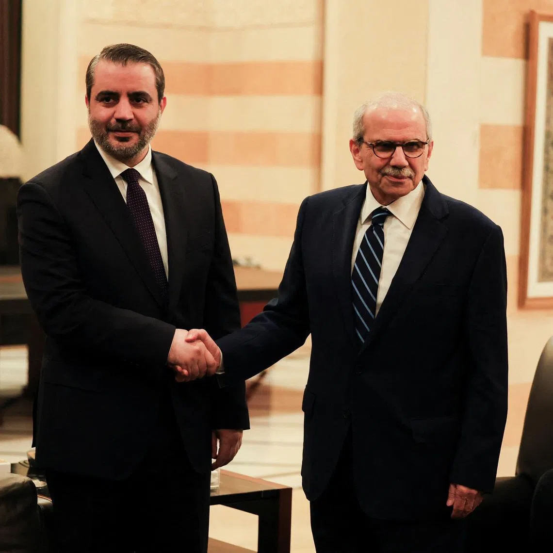 Lebanon's Prime Minister Nawaf Salam shakes hands with Syrian Foreign Minister Asaad Al-Shaibani at the Government Palace, in Beirut, Lebanon, July 2, 2026. REUTERS/Mohamed Azakir