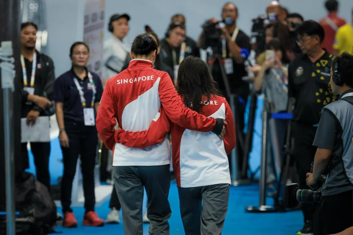 (From left) Siblings Quah Ting Wen and Quah Jing Wen walking towards waiting reporters after the medal ceremony of the women’s 100m butterfly final. Ting Wen’s victory earned her a record 63rd SEA Games medal, making her the most bemedalled athlete of the Games on Dec 13. She won two more medals after that.