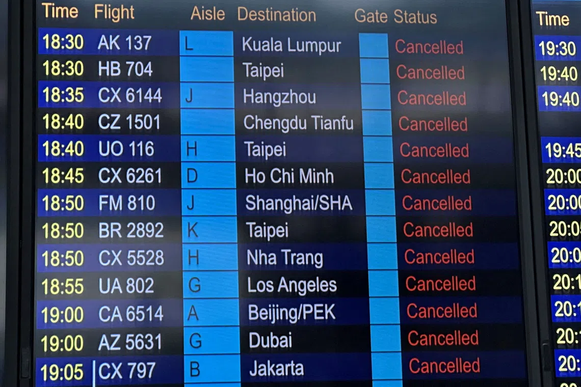 A departure board displays flight cancellations at Hong Kong International Airport, as Super Typhoon Ragasa disrupts travel, in Hong Kong, China, September 23, 2025. REUTERS/Edmond Ng