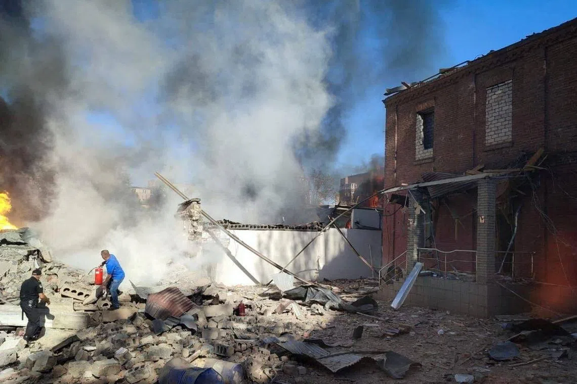 A local man trying to extinguish burning buildings at the site of a Russian missile strike in Kryvyi Rih, Dnipropetrovsk region, Ukraine, on Sept 18.