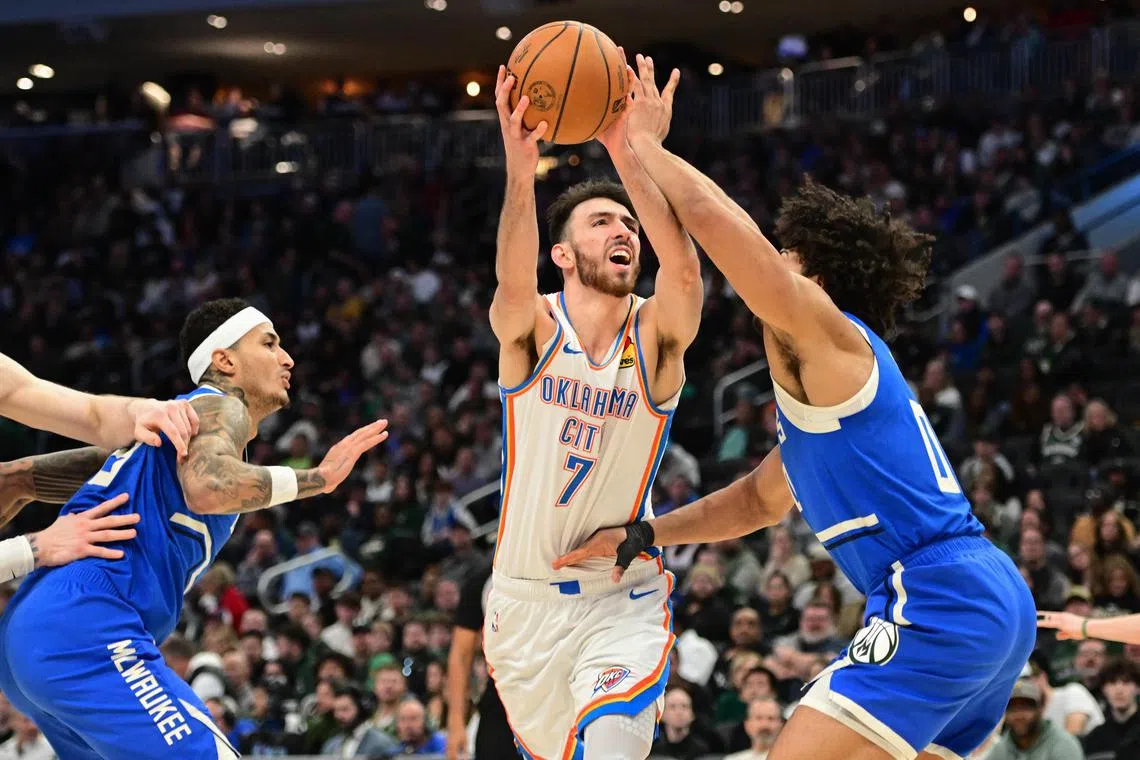 Oklahoma City Thunder centre Chet Holmgren takes a shot against Milwaukee Bucks centre Jericho Sims in the second quarter at Fiserv Forum.