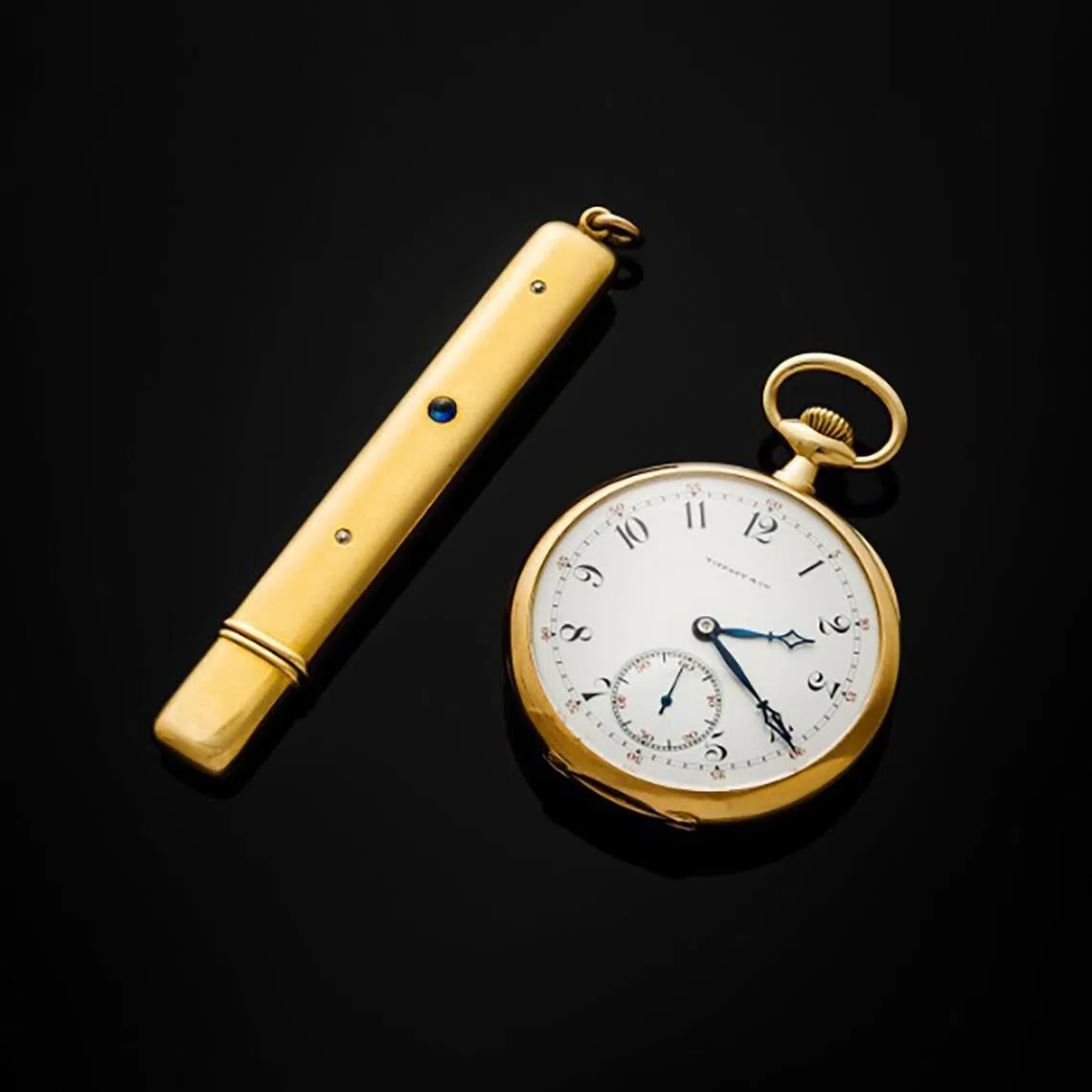 John Jacob Astor IV's Tiffany & Co.-signed Patek Philippe pocket watch (right) and a gold and sapphire Battin & Co. pencil case will be auctioned by Freeman's on April 22.