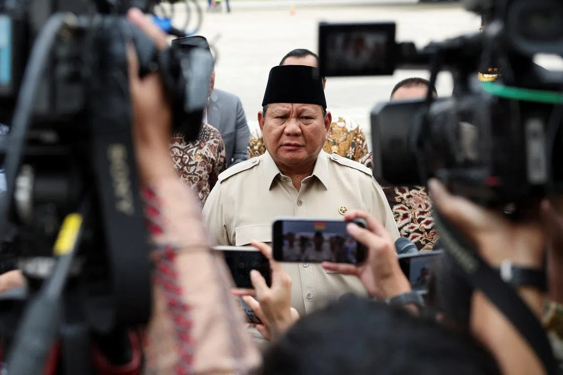 FILE PHOTO: Indonesian President Prabowo Subianto speaks to members of the media after his arrival at the Halim Perdanakusuma military airbase, following a trade deal with the United States after negotiations, which resulted in a reduction of proposed U.S. tariff rates on the country's exports to 19% from 32%, in Jakarta, Indonesia July 16, 2025. REUTERS/Ajeng Dinar Ulfiana/File Photo