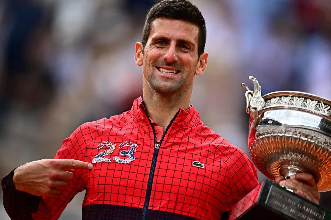 Serbia's Novak Djokovic showing the number 23, the number of Grand Slam titles he has won, as he celebrates his victory over Norway's Casper Ruud at the French Open.