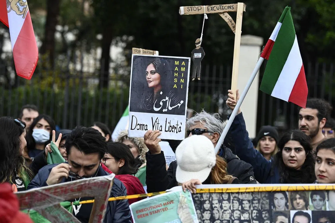 epa10359494 A person holds a placard showing late Iranian woman Mahsa Amini with a message reading 'woman, life, freedom' outside the Iranian embassy in Rome, Italy, 10 December 2022, following the execution of a protester in Iran. Iran on 08 December executed Mohsen Shekari by hanging after he was convicted of wounding a paramilitary force member during an anti-government protest following the death of Mahsa Amini, the Iranian judiciary said.  EPA-EFE/RICCARDO ANTIMIANI ITALY OUT