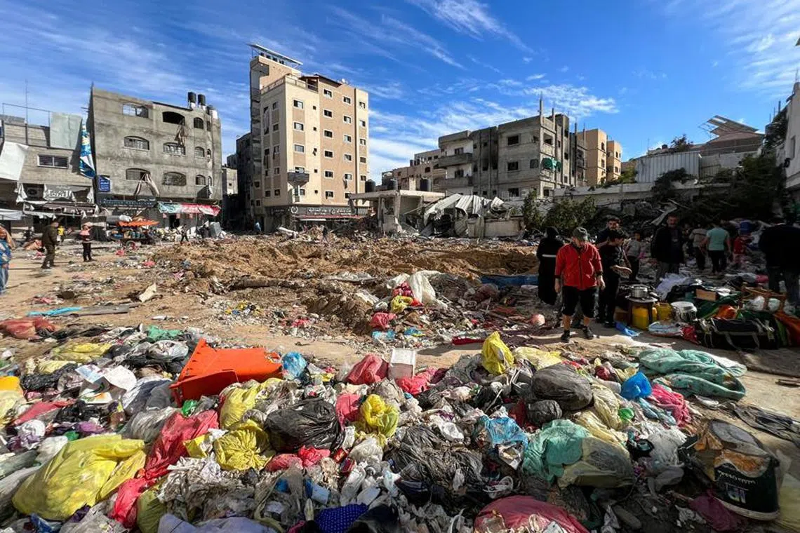 Palestinians inspect damages following an Israeli raid at Kamal Adwan hospital, amid the ongoing conflict between Israel and Palestinian Islamist group Hamas, in the northern Gaza Strip December 16, 2023. REUTERS/Fadi Alwhidifa