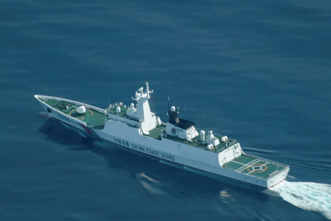 FILE PHOTO: An aerial view of a China Coast Guard ship navigating near the disputed Scarborough Shoal, as Philippine Coast Guard aircraft carrying journalists patrols the area, days after two Chinese vessels collided in the area while allegedly trying to block a Philippine supply mission, in the South China Sea, August 13, 2025. REUTERS/Adrian Portugal/File Photo