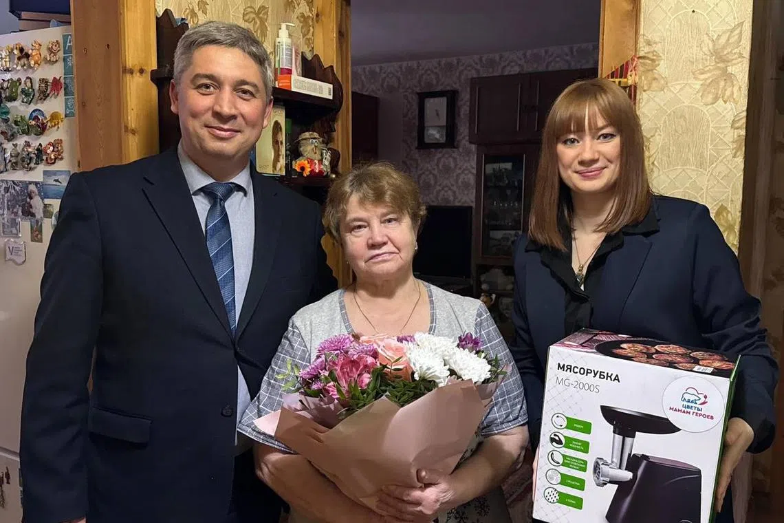 Russian officials posted photos on social media showing bereaved mothers being presented with gifts of flowers and boxed meat grinders for International Women’s Day.