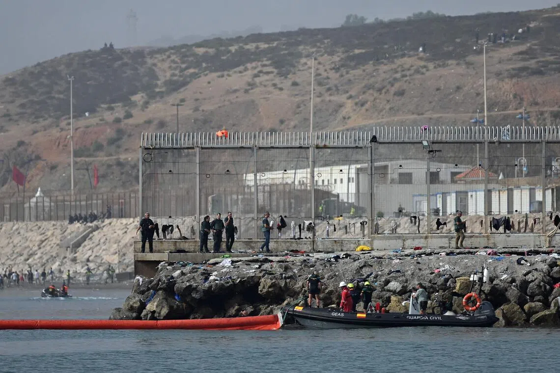 A 500m-long floating barrier is deployed in the water by a Spanish Guardia Civil boat near the border post to reinforce security following illegal crossings from Morocco into the Spanish enclave of Ceuta.