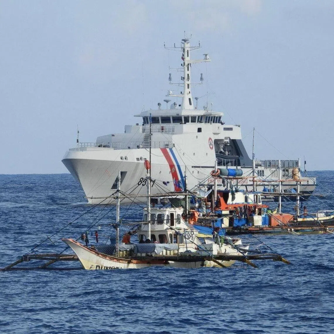 A Philippine Coast Guard vessel was among the government ships sending supplies to 40 Filipino fishing boats at Scarborough Shoal in the disputed South China Sea on September 16, 2025. 