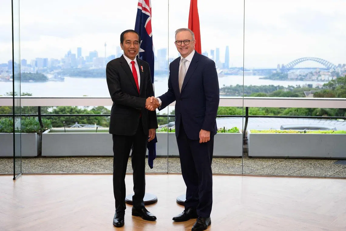 Indonesian President Joko Widodo (L) and Australian Prime Minister Anthony Albanese (R) shake hands ahead of the Annual Leaders’ Meeting at Taronga Zoo in Sydney on July 04, 2023. (Photo by DAN HIMBRECHTS / POOL / AFP)