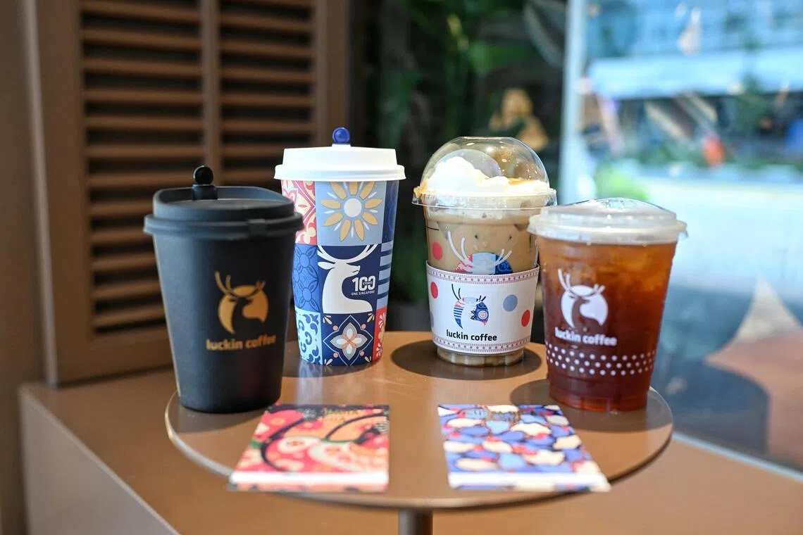 Drinks at Luckin Coffee sport its special 100th store packaging.